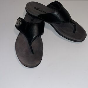 Alegria black leather thong sandals.